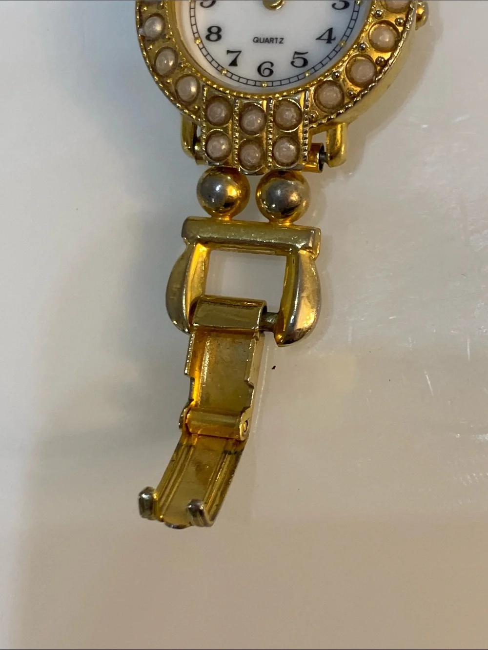 Faux pearl gold tone watch